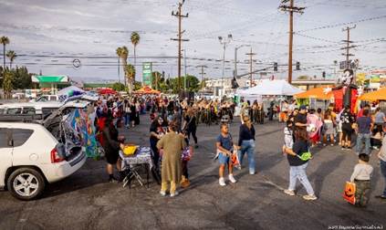 A group of people at a street market

Description automatically generated