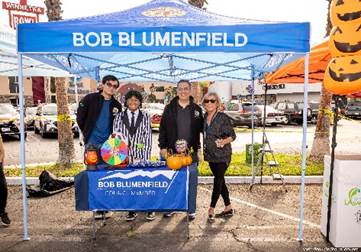 A group of people standing under a tent

Description automatically generated