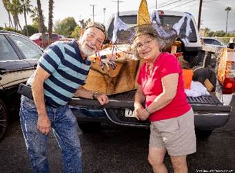 A person and person standing next to a truck

Description automatically generated